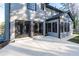 Spacious backyard with concrete patio, complemented by French doors and a charming sunroom at 160 Deer Cliff Cv, Lawrenceville, GA 30043