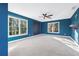 Large bedroom featuring blue walls, carpet, two large windows, and a ceiling fan at 160 Deer Cliff Cv, Lawrenceville, GA 30043