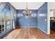 Dining room with blue walls, wainscoting, and a chandelier fixture at 160 Deer Cliff Cv, Lawrenceville, GA 30043