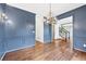 Dining room with blue walls, wainscoting, hardwood floor and chandelier at 160 Deer Cliff Cv, Lawrenceville, GA 30043