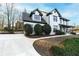 Beautiful exterior elevation with lush lawn, driveway, dark windows, and manicured landscaping at 160 Deer Cliff Cv, Lawrenceville, GA 30043