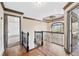 Elegant upstairs hallway featuring hardwood floors, iron railings, and a decorative ceiling medallion at 160 Deer Cliff Cv, Lawrenceville, GA 30043