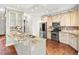 Kitchen with custom cabinetry, granite countertops, stainless steel appliances, and hardwood floors at 160 Deer Cliff Cv, Lawrenceville, GA 30043