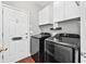 Laundry room with side by side washer and dryer and upper cabinets at 160 Deer Cliff Cv, Lawrenceville, GA 30043