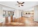 Living room with hardwood floors connects to an eat-in kitchen with a breakfast bar at 160 Deer Cliff Cv, Lawrenceville, GA 30043