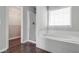 Bright bathroom featuring glass shower and bathtub combo with walk in closet at 2845 White Blossom Ln, Suwanee, GA 30024