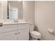This bathroom has a vanity with white cabinets and sink with a toilet next to it at 2845 White Blossom Ln, Suwanee, GA 30024