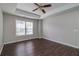 Spacious bedroom featuring tray ceiling with ceiling fan and large windows offering natural light at 2845 White Blossom Ln, Suwanee, GA 30024