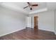 Bedroom featuring ceiling fan and hardwood floors with door leading into hallway and ensuite bathroom at 2845 White Blossom Ln, Suwanee, GA 30024