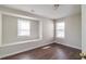 Bedroom with two windows that bring in natural light and wood floors at 2845 White Blossom Ln, Suwanee, GA 30024