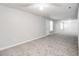 Open carpeted space with gray walls, neutral carpet, and natural lighting at 2845 White Blossom Ln, Suwanee, GA 30024