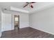 Bedroom with ceiling fan, hardwood floors, walk-in closet, and ensuite bathroom with large soaking tub at 2845 White Blossom Ln, Suwanee, GA 30024