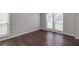 Bright bedroom featuring hardwood floors, neutral walls, and abundant natural light at 2845 White Blossom Ln, Suwanee, GA 30024