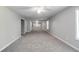 Large carpeted bonus room featuring a ceiling fan and natural light at 2845 White Blossom Ln, Suwanee, GA 30024