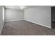 Large carpeted bonus room featuring a ceiling fan and natural light at 2845 White Blossom Ln, Suwanee, GA 30024
