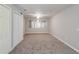 Large carpeted bonus room featuring a ceiling fan and natural light at 2845 White Blossom Ln, Suwanee, GA 30024