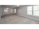 Large carpeted bonus room featuring a ceiling fan and natural light at 2845 White Blossom Ln, Suwanee, GA 30024