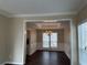 Elegant dining room boasting dark wood floors, a coffered ceiling, and a stylish chandelier at 2845 White Blossom Ln, Suwanee, GA 30024