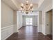 Open dining space with hardwood floors, wainscoting details, and an ornate chandelier at 2845 White Blossom Ln, Suwanee, GA 30024
