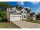 Lovely traditional-style home with an attached two-car garage and a spacious driveway at 2845 White Blossom Ln, Suwanee, GA 30024