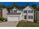 Charming two-story home features a two-car garage and a well-manicured lawn at 2845 White Blossom Ln, Suwanee, GA 30024