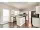 Charming kitchen with island, granite countertops, and stainless steel appliances at 2845 White Blossom Ln, Suwanee, GA 30024