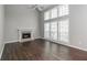 Bright living room with fireplace, hardwood floors, ceiling fan, and large windows at 2845 White Blossom Ln, Suwanee, GA 30024