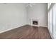 Bright living room with fireplace, hardwood floors, ceiling fan, and large windows at 2845 White Blossom Ln, Suwanee, GA 30024