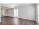 Spacious living room with hardwood floors, large windows, and elegant chandelier at 2845 White Blossom Ln, Suwanee, GA 30024