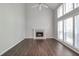 Bright living room with fireplace, hardwood floors, ceiling fan, and large windows at 2845 White Blossom Ln, Suwanee, GA 30024