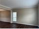 Inviting living room with dark hardwood floors, wainscoting, neutral paint, and natural light at 2845 White Blossom Ln, Suwanee, GA 30024