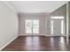 Well-lit living room with a large window, hardwood floors, and fresh neutral paint at 2845 White Blossom Ln, Suwanee, GA 30024