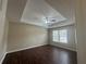 Relaxing main bedroom with tray ceiling, dark wood floors and lots of natural light at 2845 White Blossom Ln, Suwanee, GA 30024