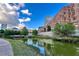 Stunning view of building architecture reflecting into the community pond and lush landscaping at 567 Ponce De Leon Ne Ave # 502, Atlanta, GA 30308