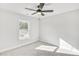 Cozy bedroom with neutral carpet, ceiling fan, and natural light from the window at 5711 Tillman Way, Powder Springs, GA 30127