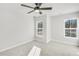 Spacious bedroom featuring neutral carpet, ceiling fan, and two windows at 5711 Tillman Way, Powder Springs, GA 30127