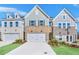 Charming townhomes with brick and siding exteriors, featuring two-car garages and well-maintained lawns at 5711 Tillman Way, Powder Springs, GA 30127