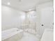 Main bathroom featuring a large tub, step-in shower and white marble walls at 5711 Tillman Way, Powder Springs, GA 30127