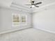 Comfortable bedroom with soft carpet, ceiling fan, and bright windows at 5711 Tillman Way, Powder Springs, GA 30127
