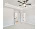 Bright main bedroom with tray ceilings and soft neutral colored carpet at 5711 Tillman Way, Powder Springs, GA 30127