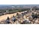 Aerial view of a residential area featuring tree-lined streets and beautiful homes near a golf course at 1021 Windermere Xing, Cumming, GA 30041