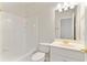 A bright bathroom features white tile, a vanity, and a toilet at 1021 Windermere Xing, Cumming, GA 30041