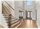 Elegant foyer with wood staircase, hardwood floors, and decorative front door at 1021 Windermere Xing, Cumming, GA 30041