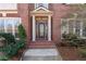 Elegant brick home entrance with a detailed, glass-paneled front door at 1021 Windermere Xing, Cumming, GA 30041