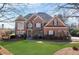 Charming two-story brick home with well-manicured lawn and mature landscaping at 1021 Windermere Xing, Cumming, GA 30041