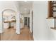 Hallway with hardwood floors leading into kitchen with white cabinets at 1021 Windermere Xing, Cumming, GA 30041