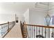 Upstairs hallway with wood and iron railing and decorative lighting at 1021 Windermere Xing, Cumming, GA 30041