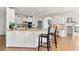 Bright kitchen with an island, counter seating, white cabinets, and modern appliances at 1021 Windermere Xing, Cumming, GA 30041