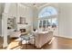 Bright living room with fireplace, built-in shelving, and a large arched window at 1021 Windermere Xing, Cumming, GA 30041