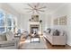 Cozy living room featuring a stone fireplace and lots of natural light at 1021 Windermere Xing, Cumming, GA 30041